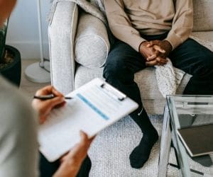Man standing thoughtfully in a park, showcasing the journey of recovery through Alcohol Detox in Nashville for a healthier future.